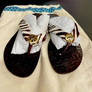 Tory Burch Thora flip flop in brown and cream zebra faux fur with gold emblem!